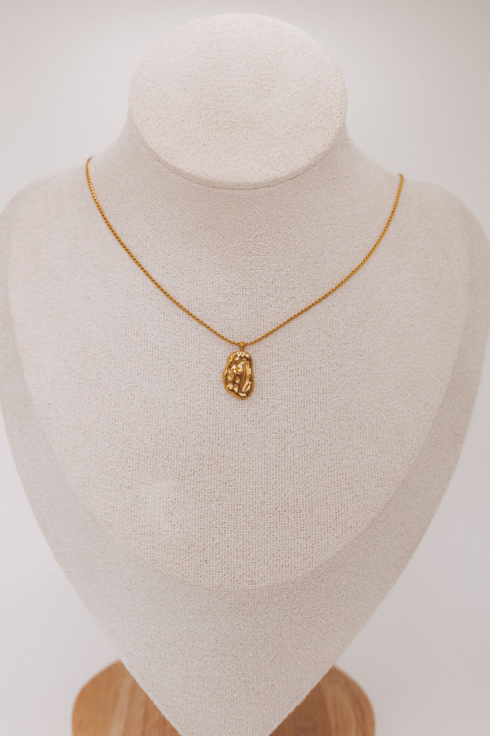hammered metal pendant necklace display