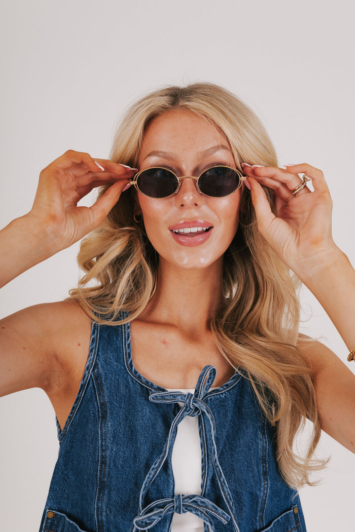 gold rimmed geometric sunglasses