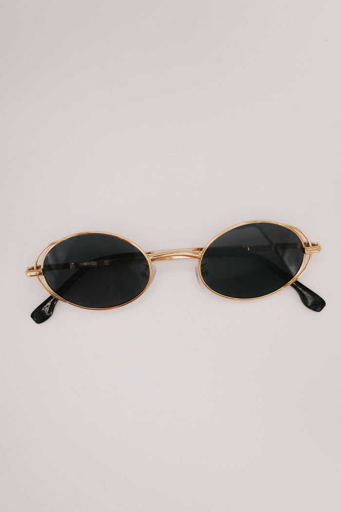 gold rimmed geometric sunglasses