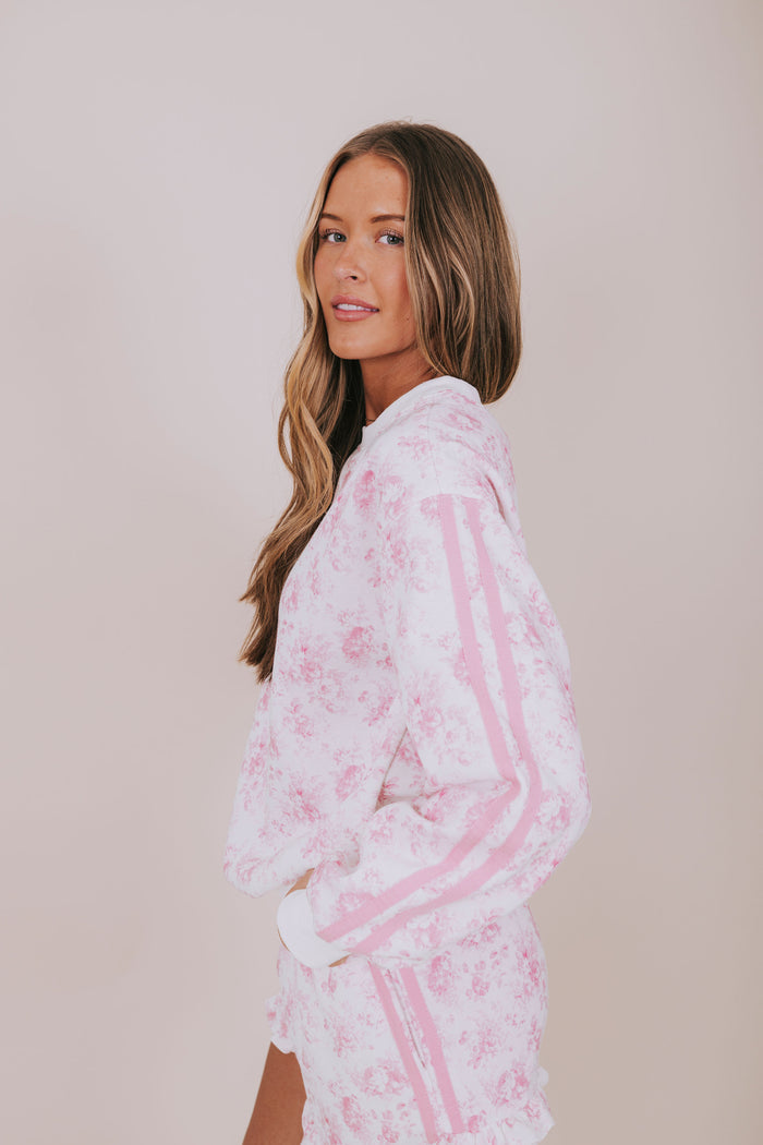 pink floral and white sweatshirt side
