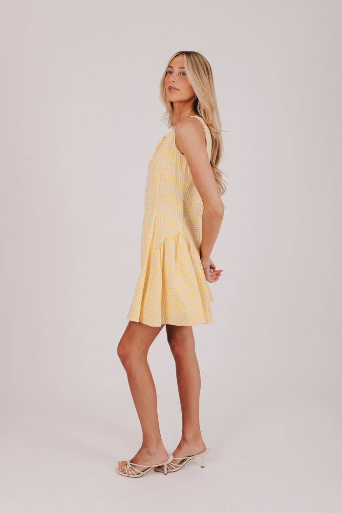 Yellow and white gingham sleeveless mini dress with tied bow and basque waist