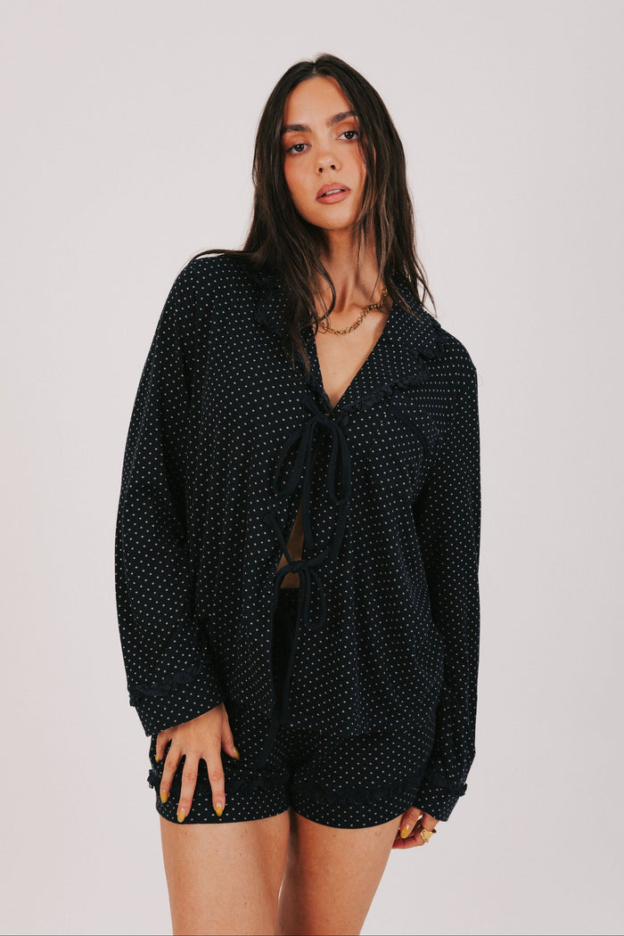 polka dot long sleeve top with bows and ruffled trim front