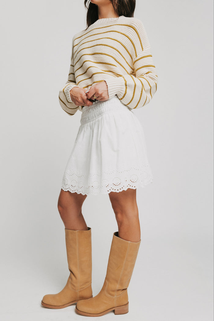 white mini skirt with eyelet on hemline side full