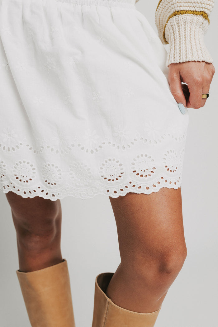 white mini skirt with eyelet on hemline close