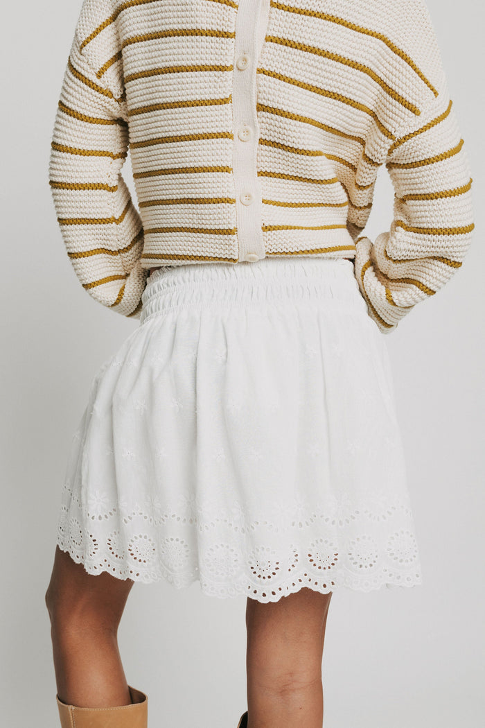 white mini skirt with eyelet on the hemline back