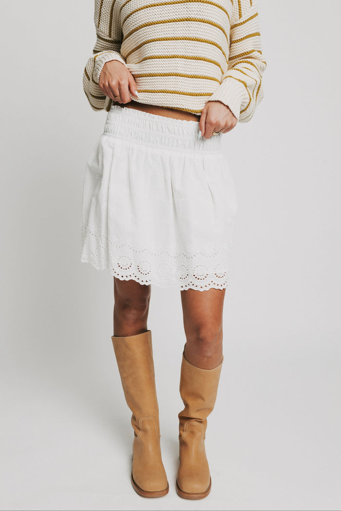 white mini skirt with eyelet on the hemline full