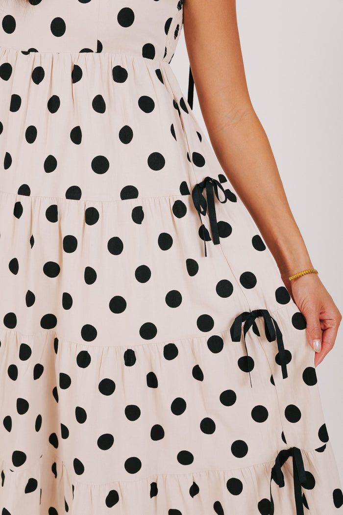 cream and black polka dot dress with bow details close up