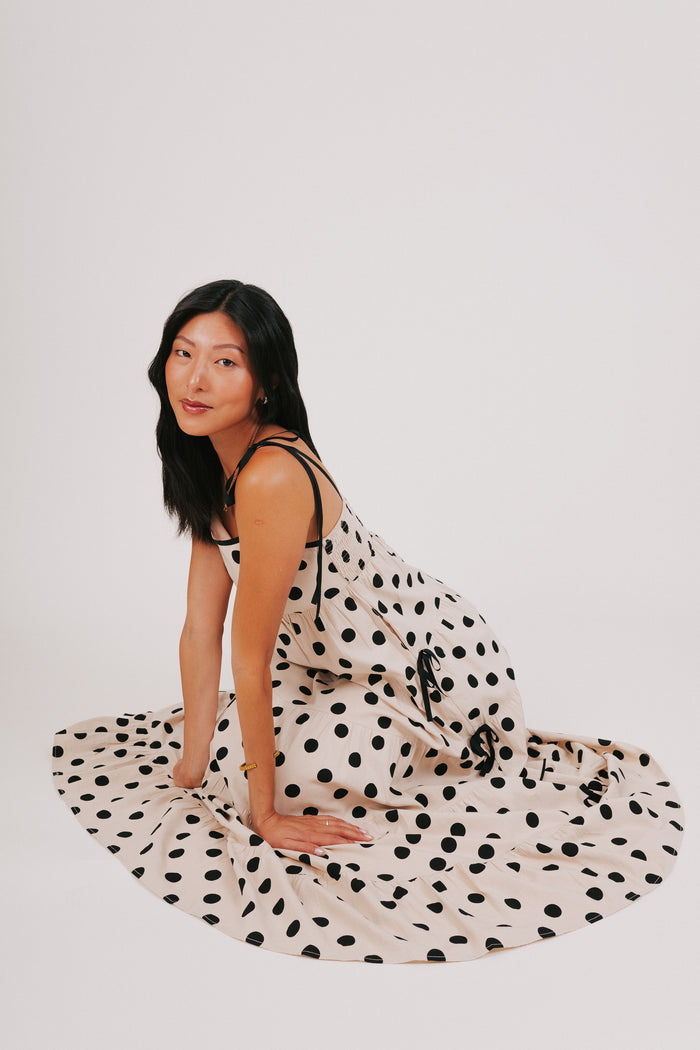 cream and black polka dot dress with bow details model