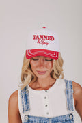 white and red baseball trucker cap with embroidered "tanned and tipsy"