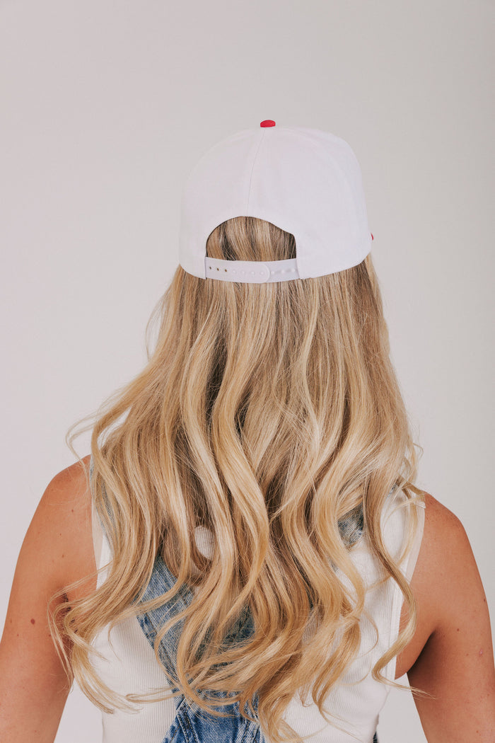 white and red baseball trucker cap with embroidered "tanned and tipsy"
