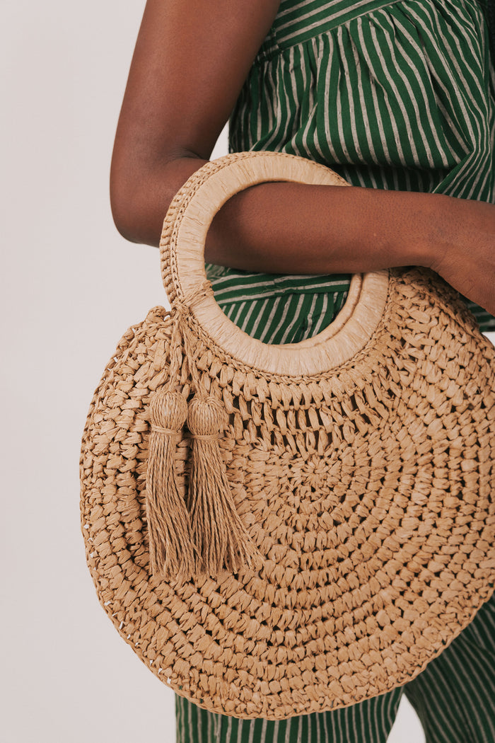 circular woven bag with tassels
