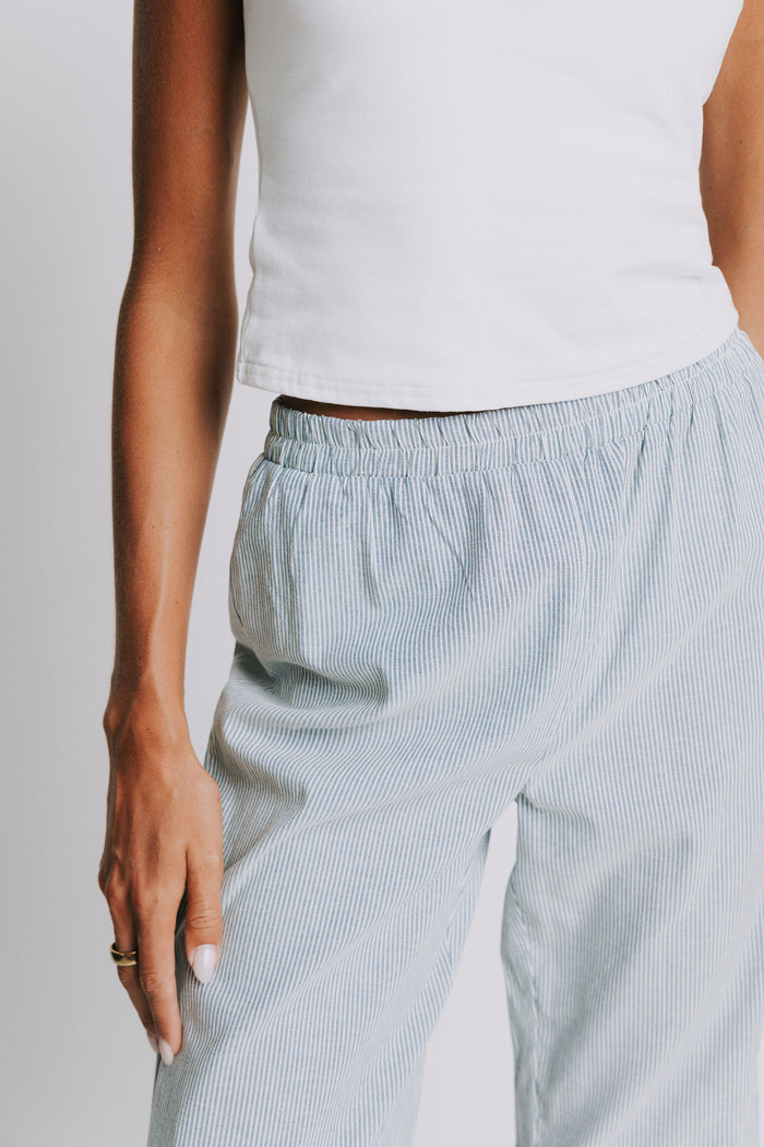 blue and white striped pants with elastic waist and ruffled hem close