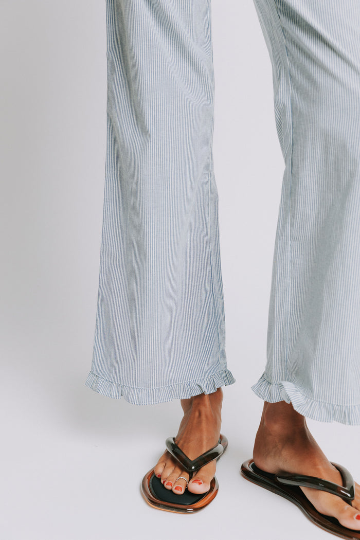 blue and white striped pants with elastic waist and ruffled hem detail