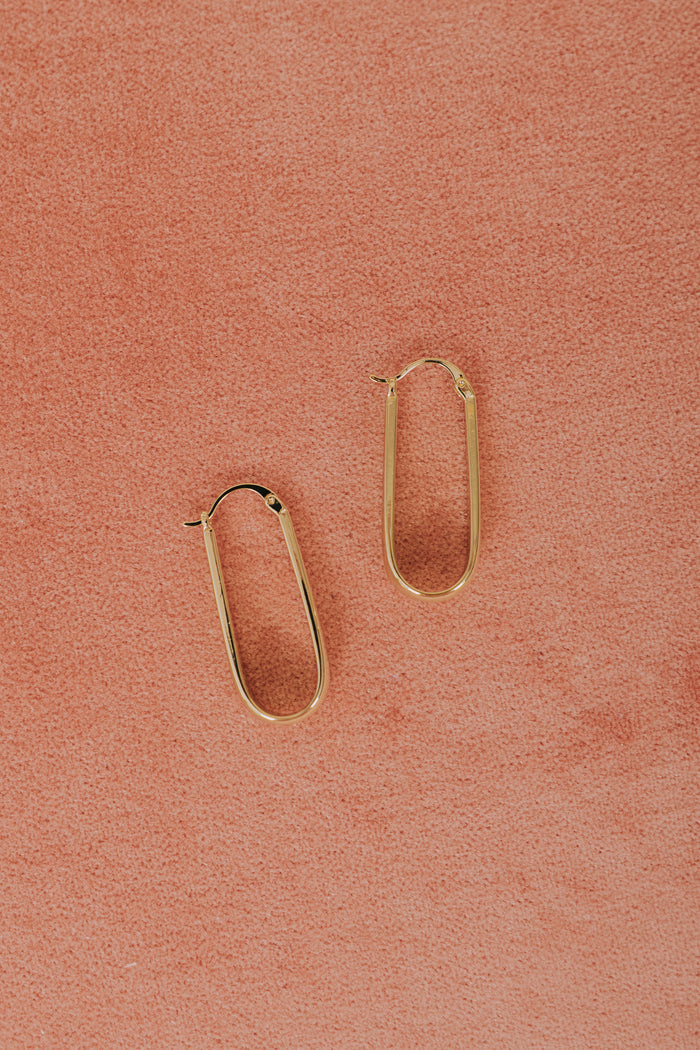 gold elongated tapered latch back earrings flatlay
