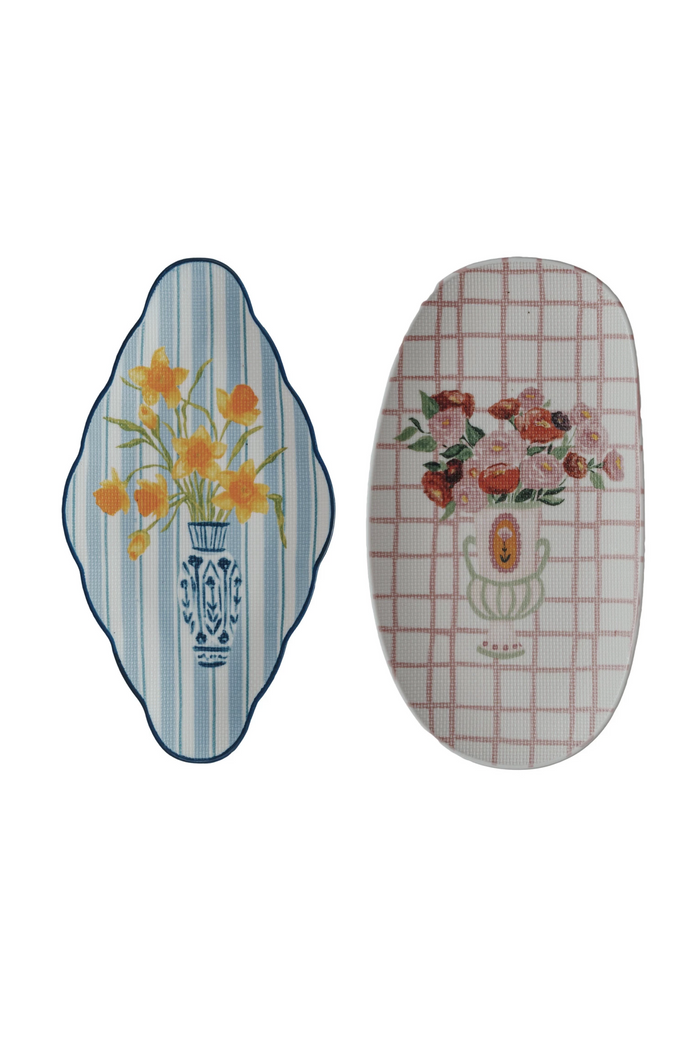 Two stoneware plates, one with blue stripes and a vase of yellow flowers, and the other with a pink checkered pattern and a vase of multicolored flowers.