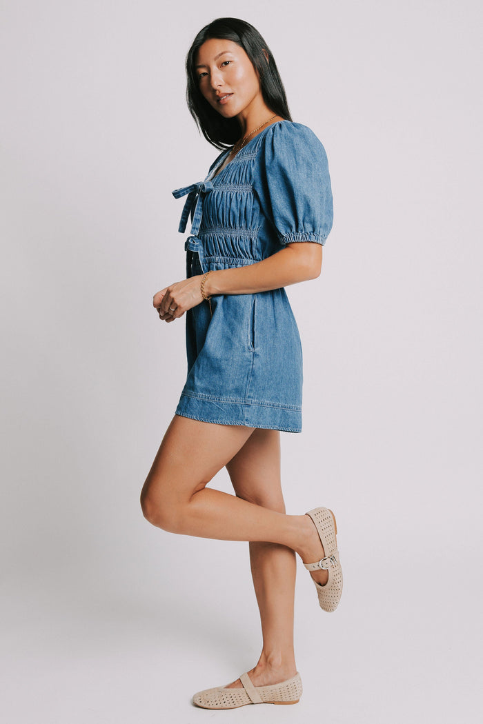 blue denim v neck romper with bows and gathered detail side