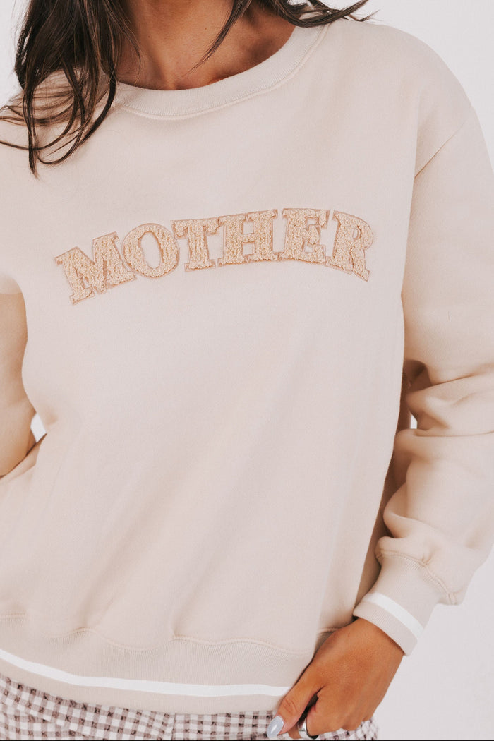 tan sweatshirt with mother printed front