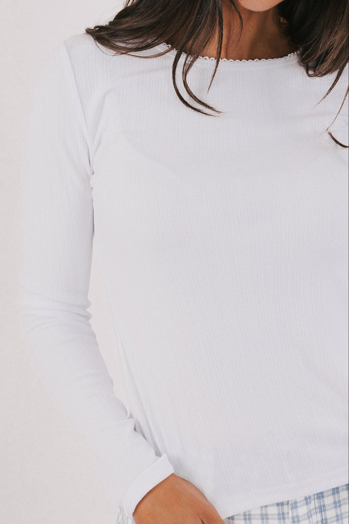 white long sleeve top with trim detail