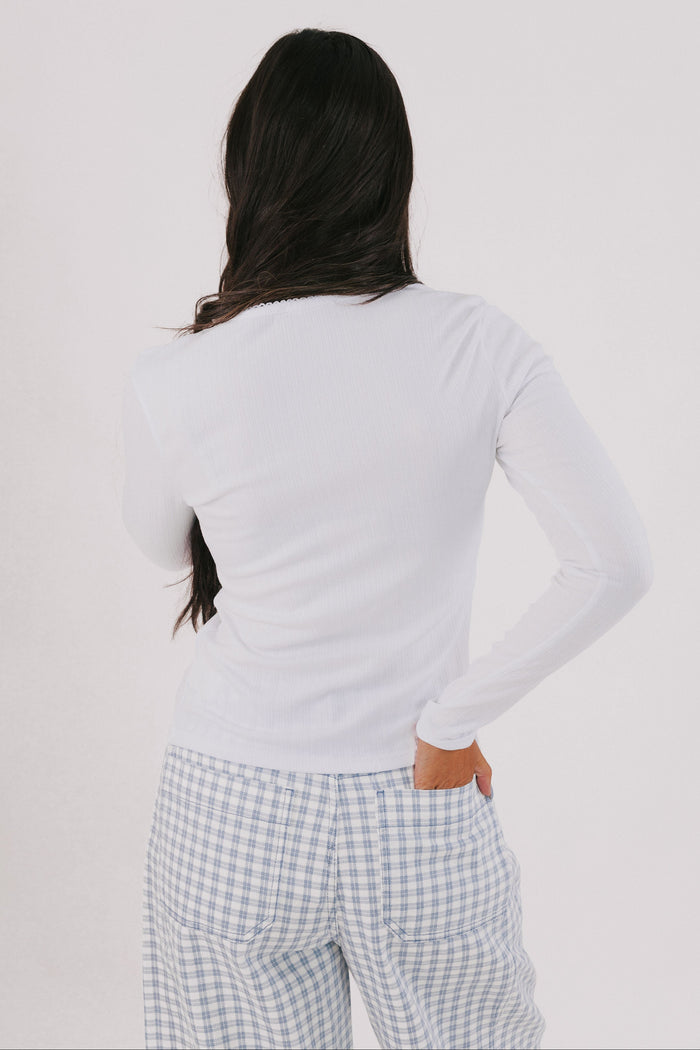 white long sleeve top with trim detail back