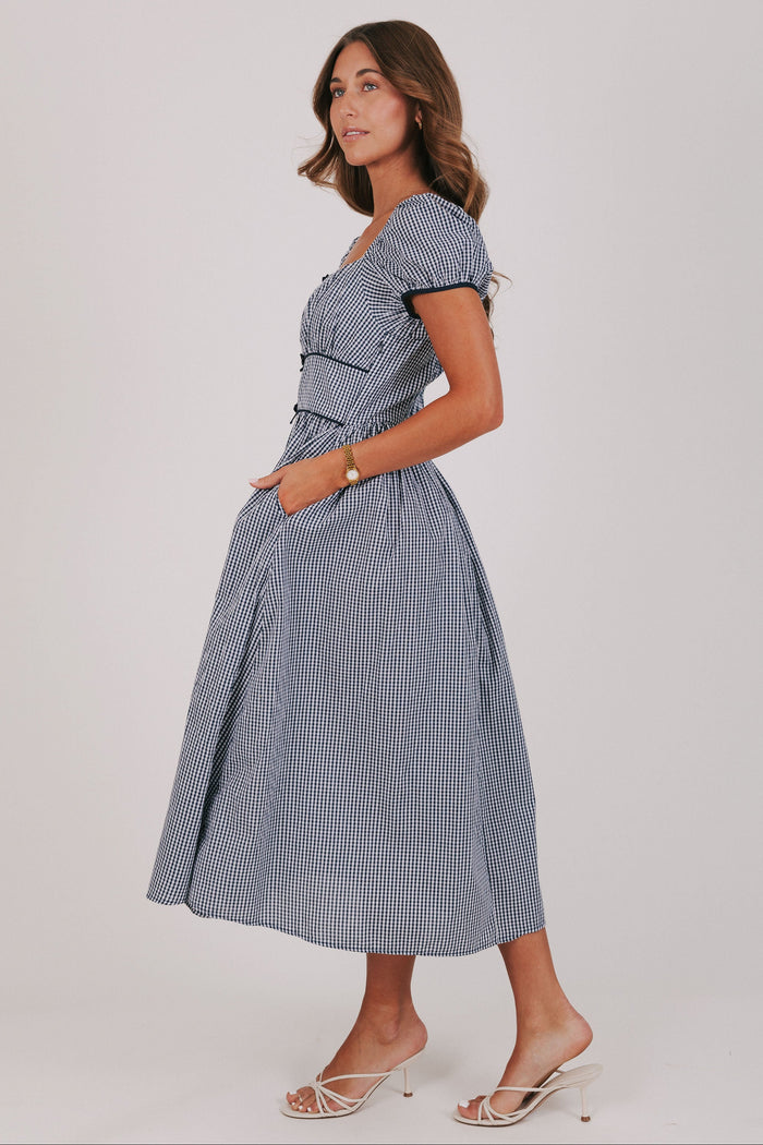 blue gingham dress with puff sleeves and bow details side