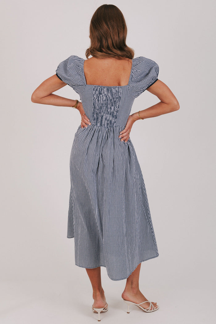 blue gingham dress with puff sleeves and bow details back