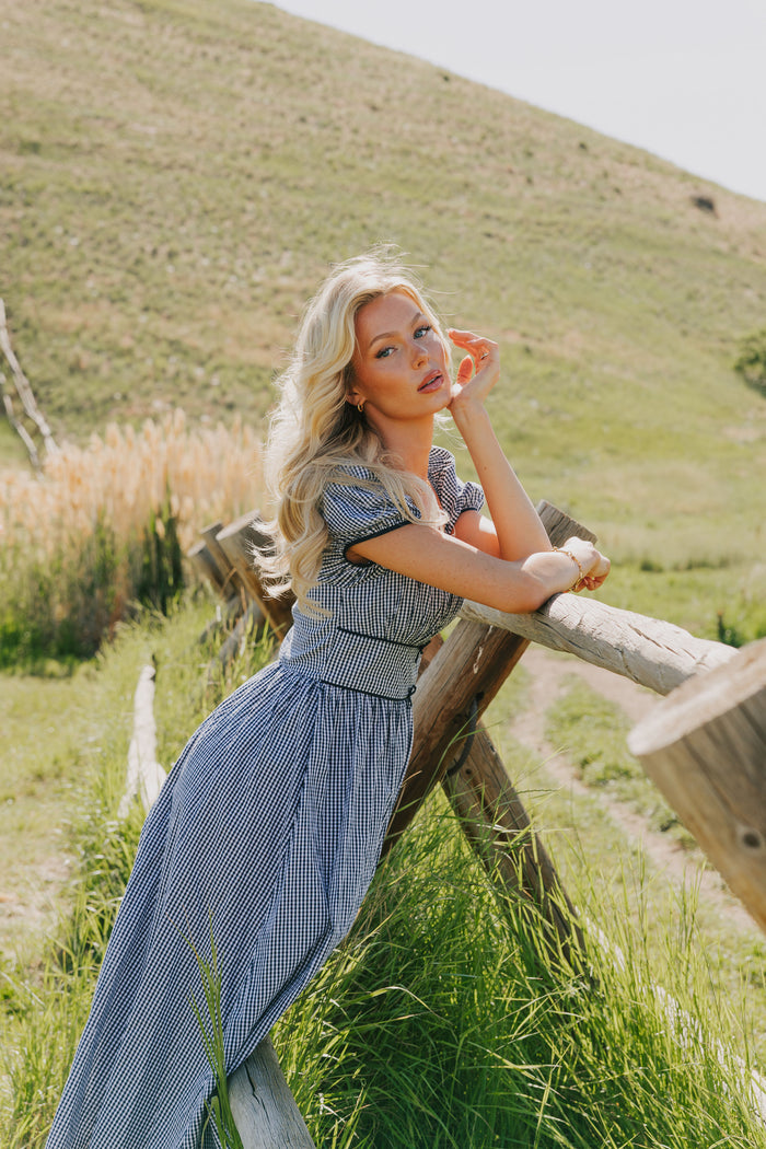 blue gingham dress with puff sleeves and bow details lifestyle