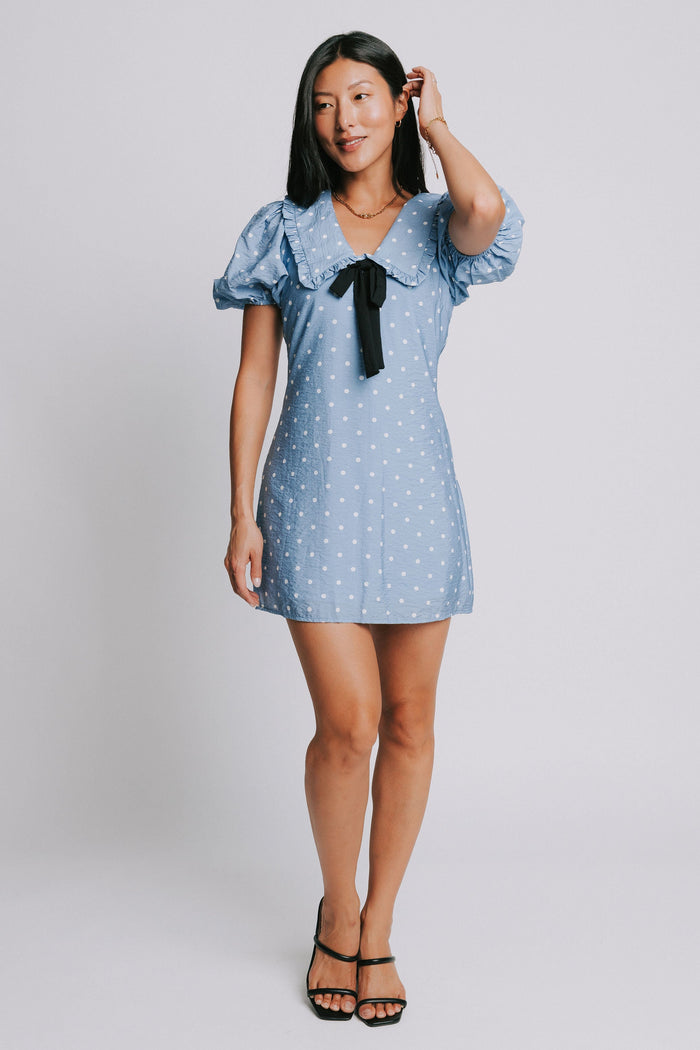 blue and white polka dot mini dress with puff sleeves and collar