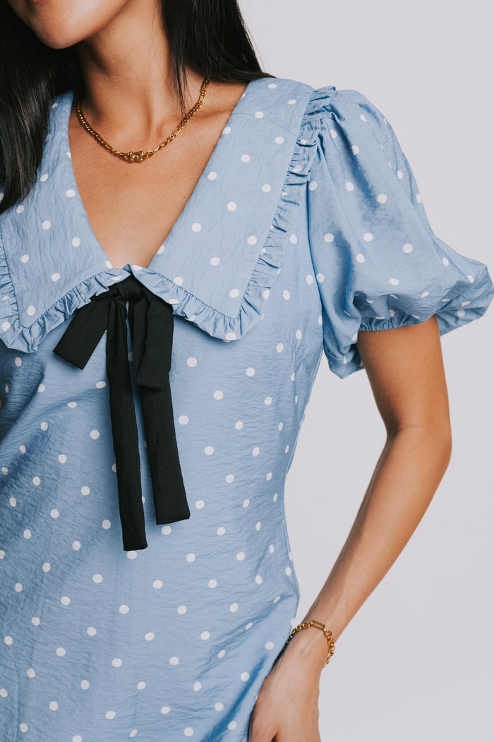 blue and white polka dot mini dress with puff sleeves and collar close