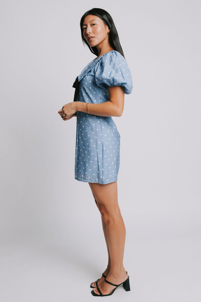 blue and white polka dot mini dress with puff sleeves and collar side