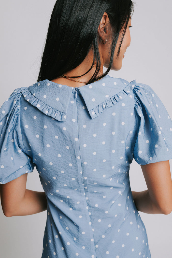 blue and white polka dot mini dress with puff sleeves and collar back close