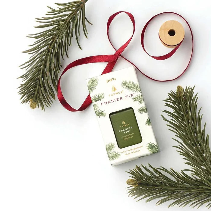 Frasier Fir diffuser refill with red ribbon and green branches on a white background
