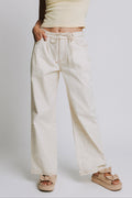 ivory jeans with tie at the waist and contrast stitching