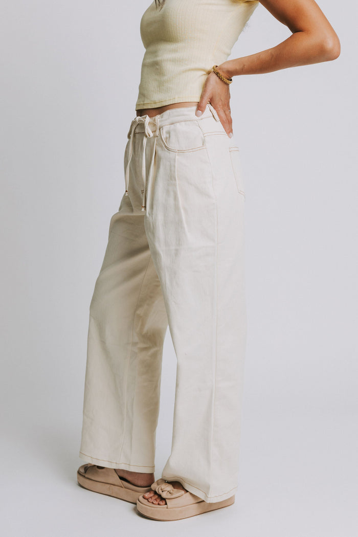 ivory jeans with tie at the waist and contrast stitching side