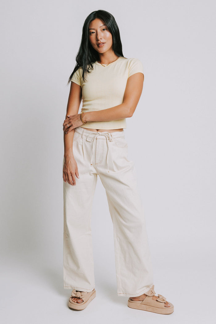 ivory jeans with tie at the waist and contrast stitching