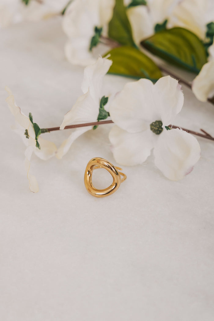 Gold circle ring with cut out empty space