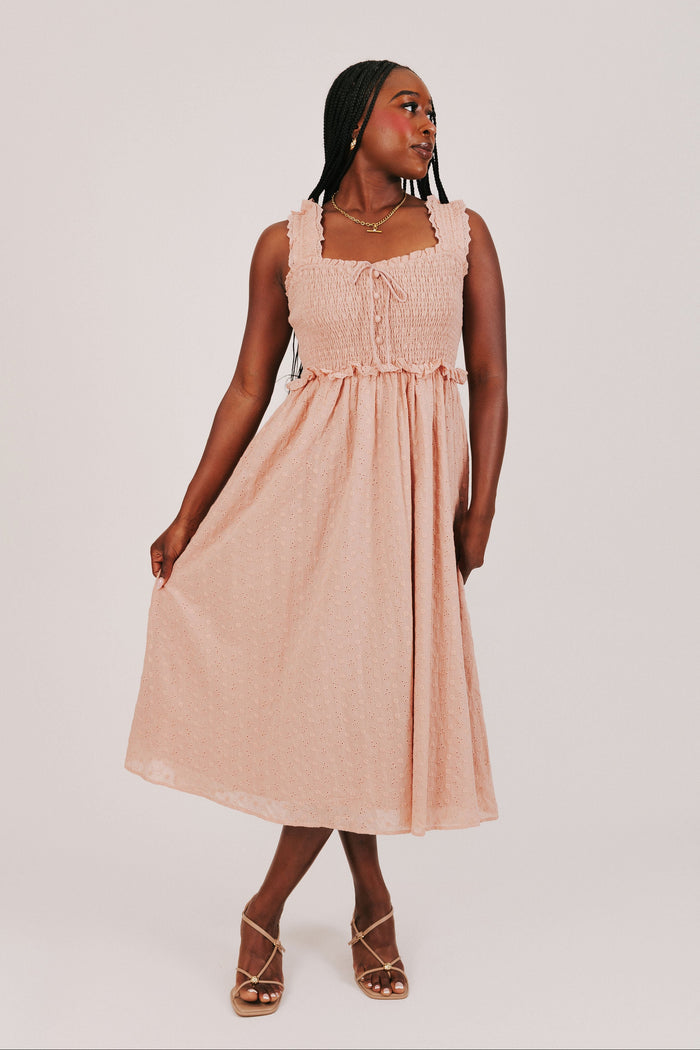 sunset colored midi dress with shirred bodice model