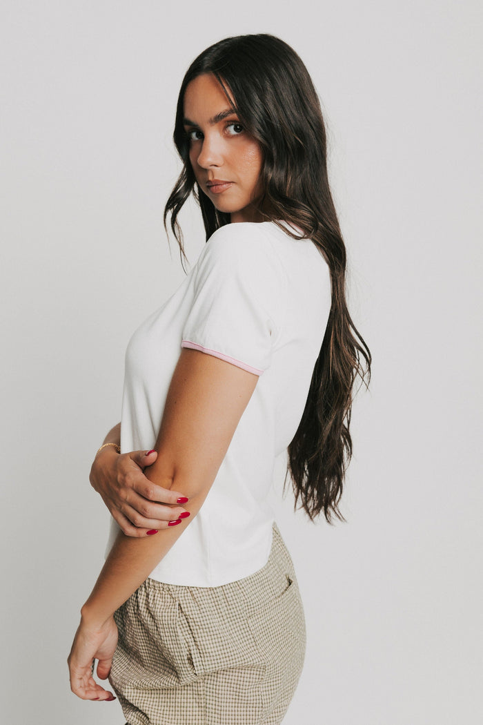 white tee with pink trim and rose applique side