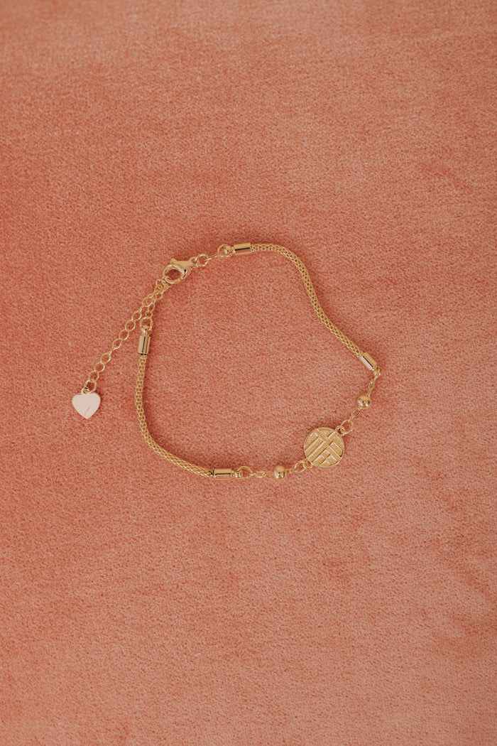 gold mesh chain circle pendant bracelet flatlay